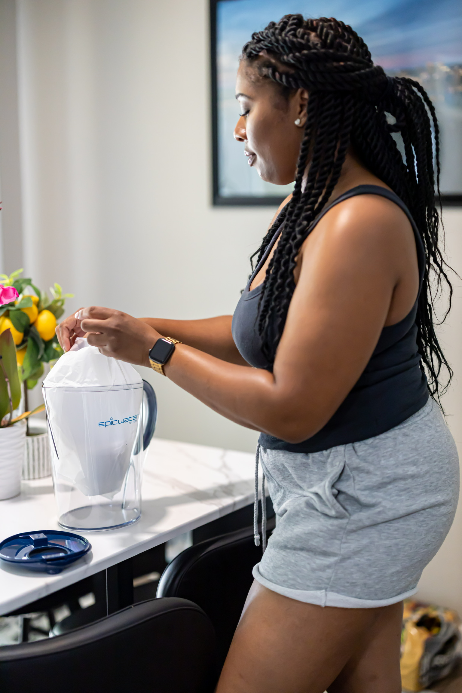 Water filter pitcher pouring filtered water in a kitchen